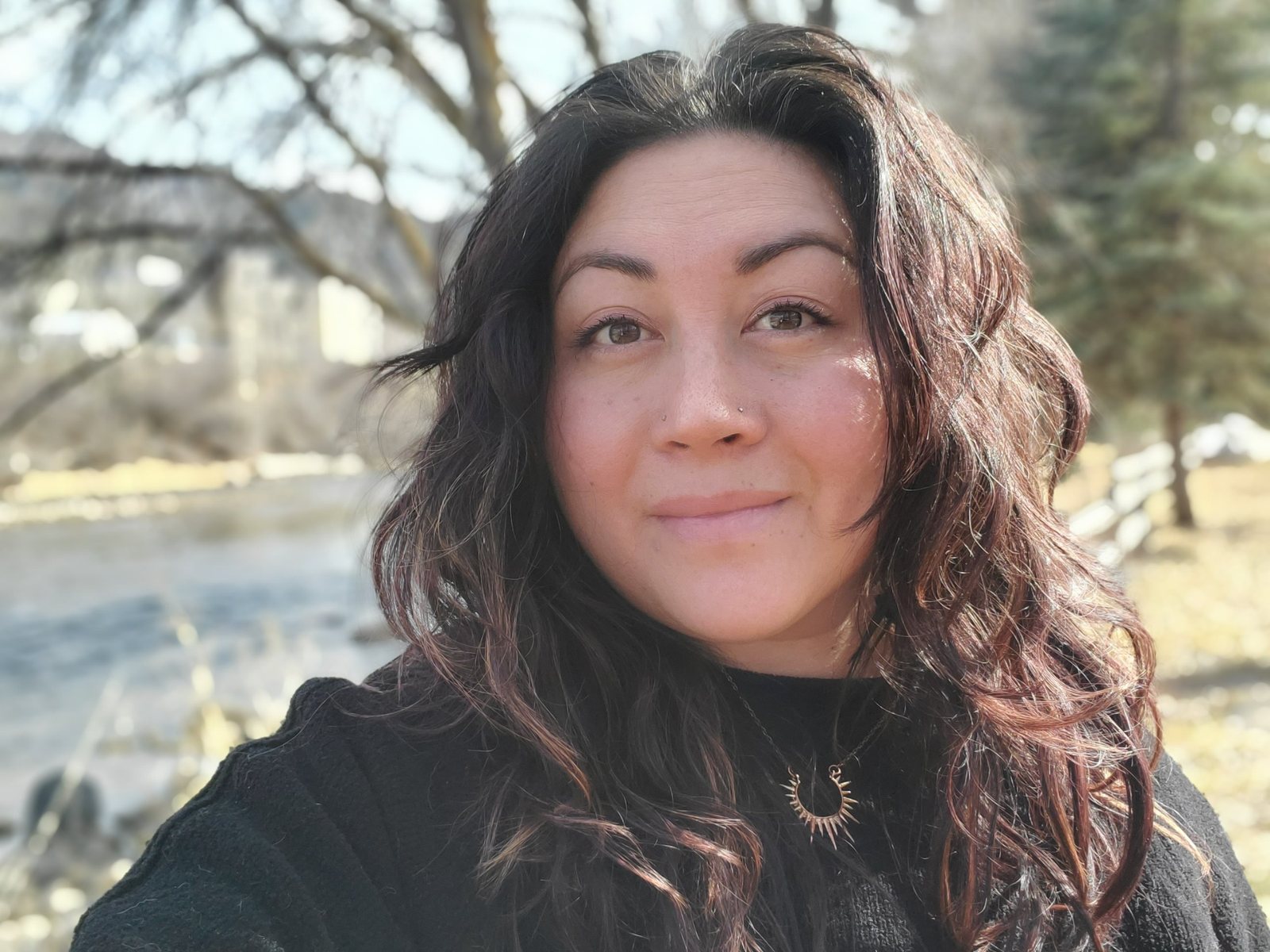 Alicia smiling by the river
